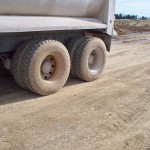 Final proofroll using a loaded tandem axle dump truck after subgrade has cured.